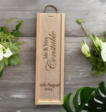 Load image into Gallery viewer, Close-up of custom engraving on a wooden wine box, featuring personalised text and logos.&quot;
